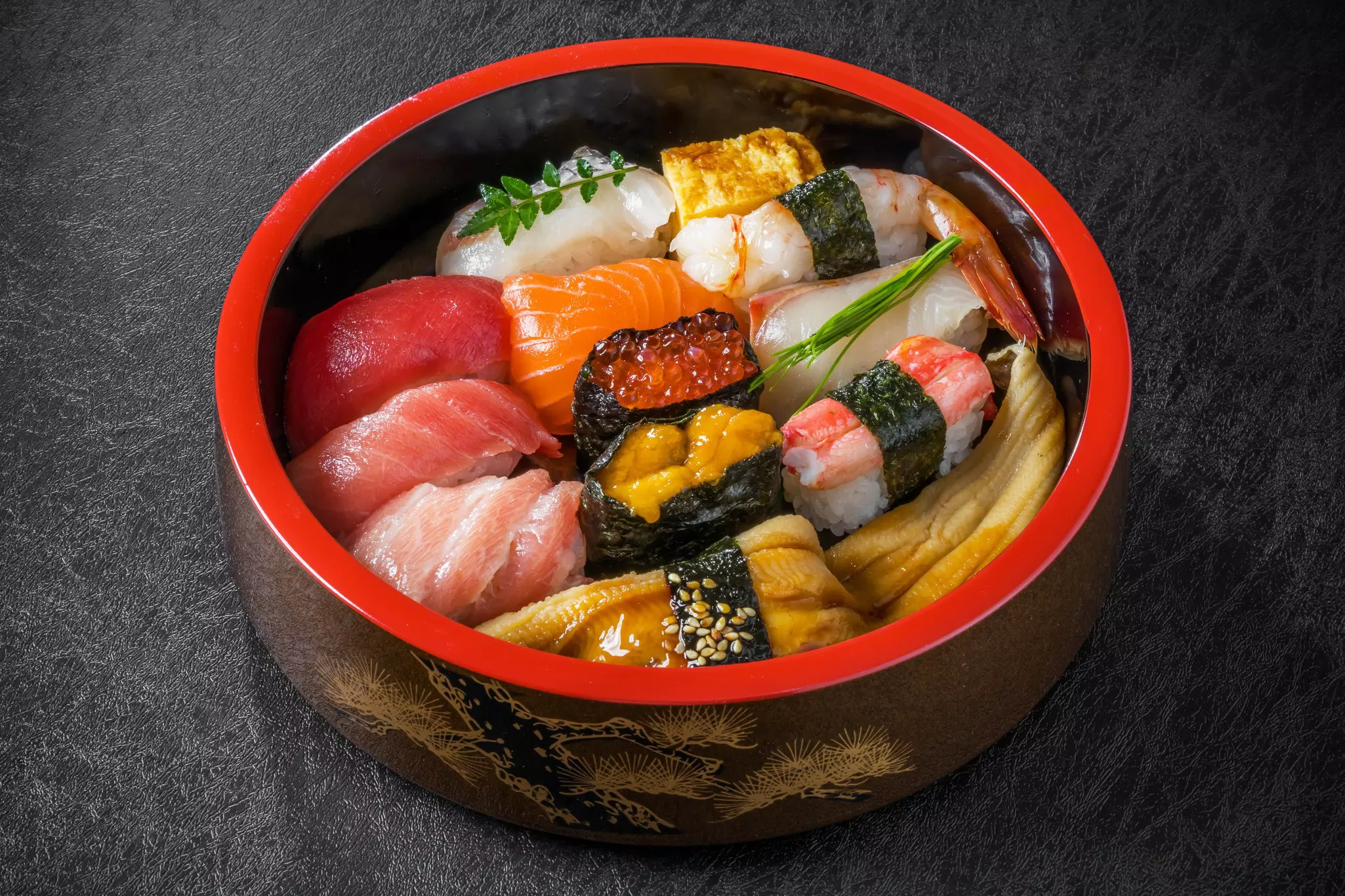 Stylishly presented suchi in Tokyo, Japan, with a red bowl.