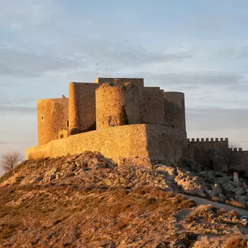 View of the Castillo de Consuegra at sunset in Spain.