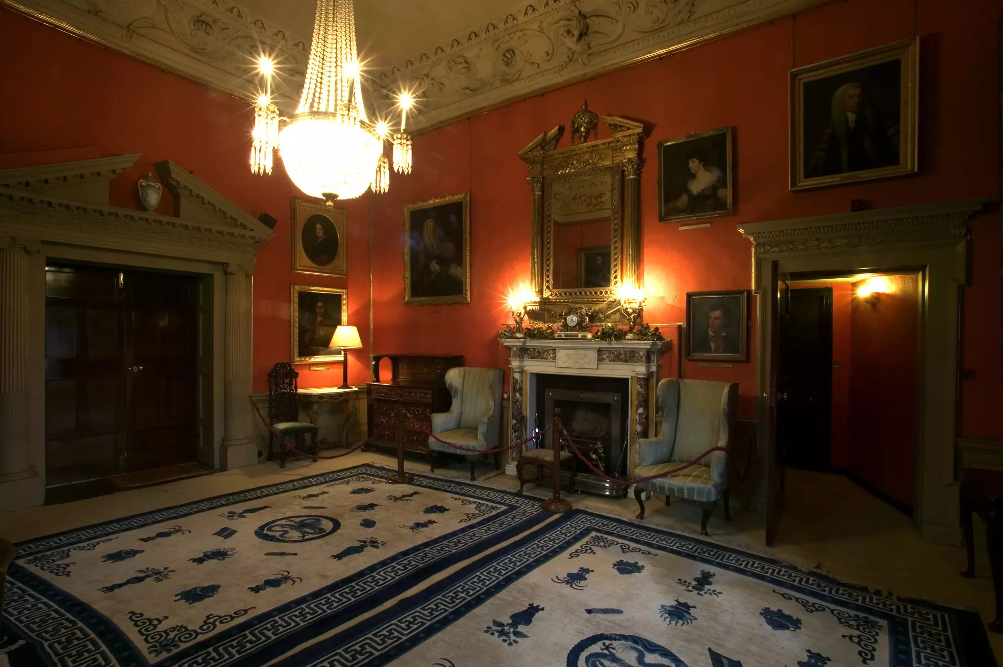 The interior of Malahide Castle, with red walls and elegant vintage furnishings