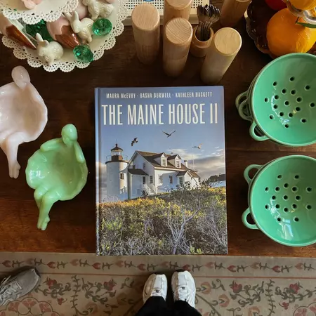 Books and housewares laid out on a table in a shop.