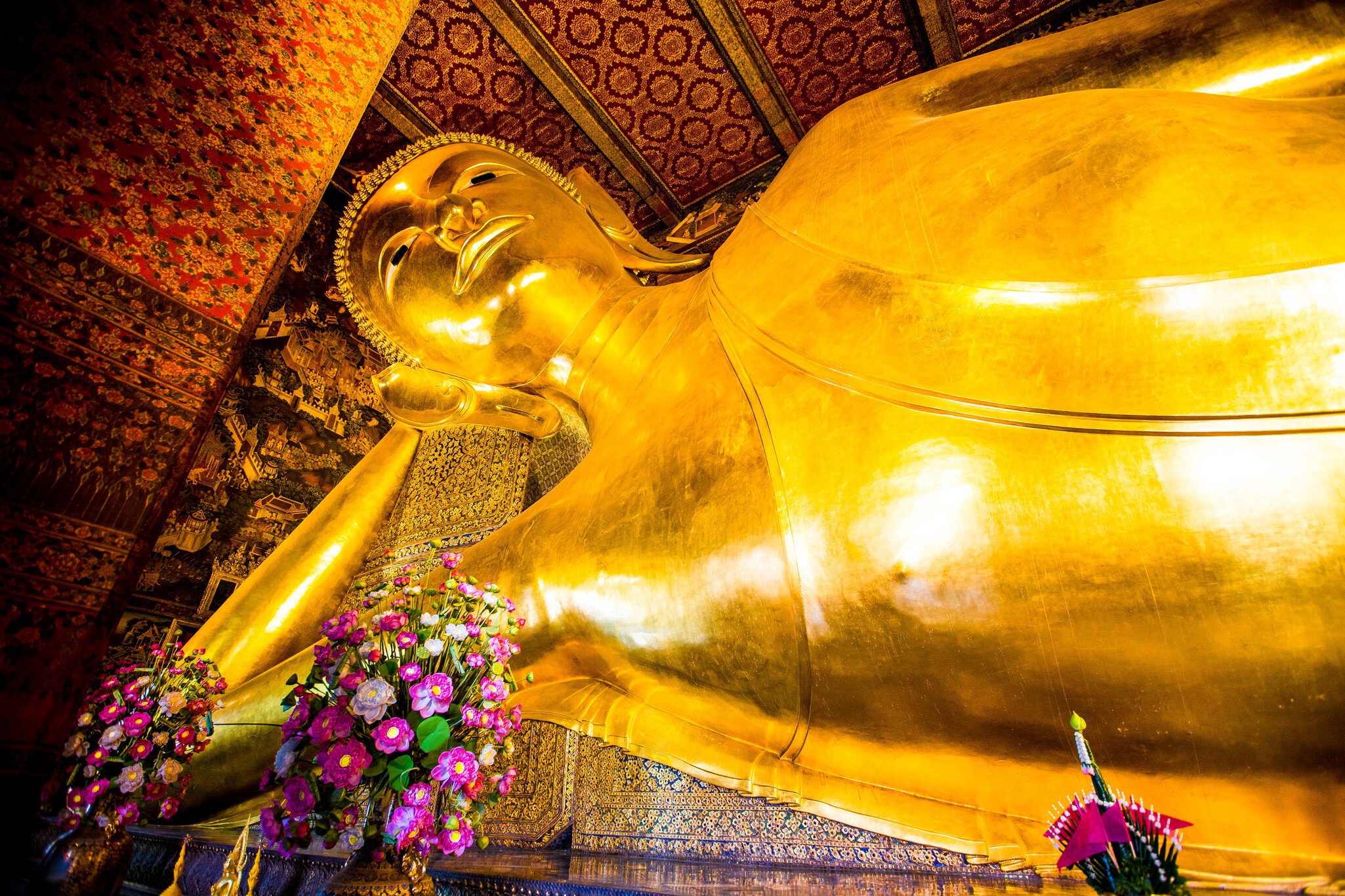 A golden, giant Buddha statue lies on its side