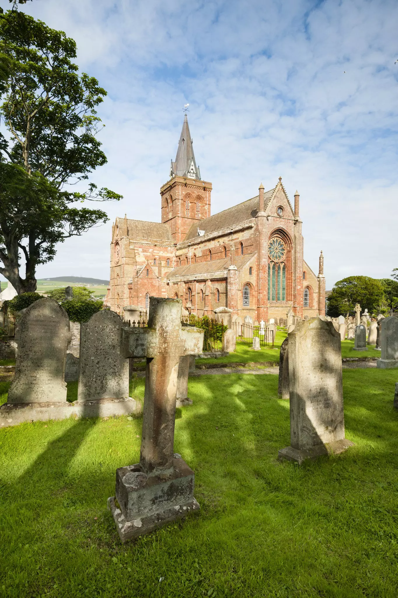 A grand medieval cathedral with a graveyard.