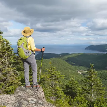 Female hiker standing at the top of a mountain in Cape Breton Highlands National Park.
512302024
Scenics - Nature, Canada, Hiking Pole, Body Conscious, Backpack, Travel Destinations, Horizontal, Getting Away From It All, Tourist, Hiking, Nature, Mature Women, Travel, Healthy Lifestyle, Eco Tourism, Beauty In Nature, Wellbeing, Hat, Maritime Provinces, Cape Breton Island, Yellow, Vacations, Gulf of St Lawrence, Recreational Pursuit, Cape Breton Highlands National Park, 103626, Nova Scotia, Cabot Trail, On Top Of, Women, Tourism, Outdoor Pursuit, Outdoors, Footpath, People, Summer, Mountain, Photography, Wilderness Area, Adult, Landscape, Active Seniors, Mature Adult, National Park, Landscape - Scenery, Mountain Peak