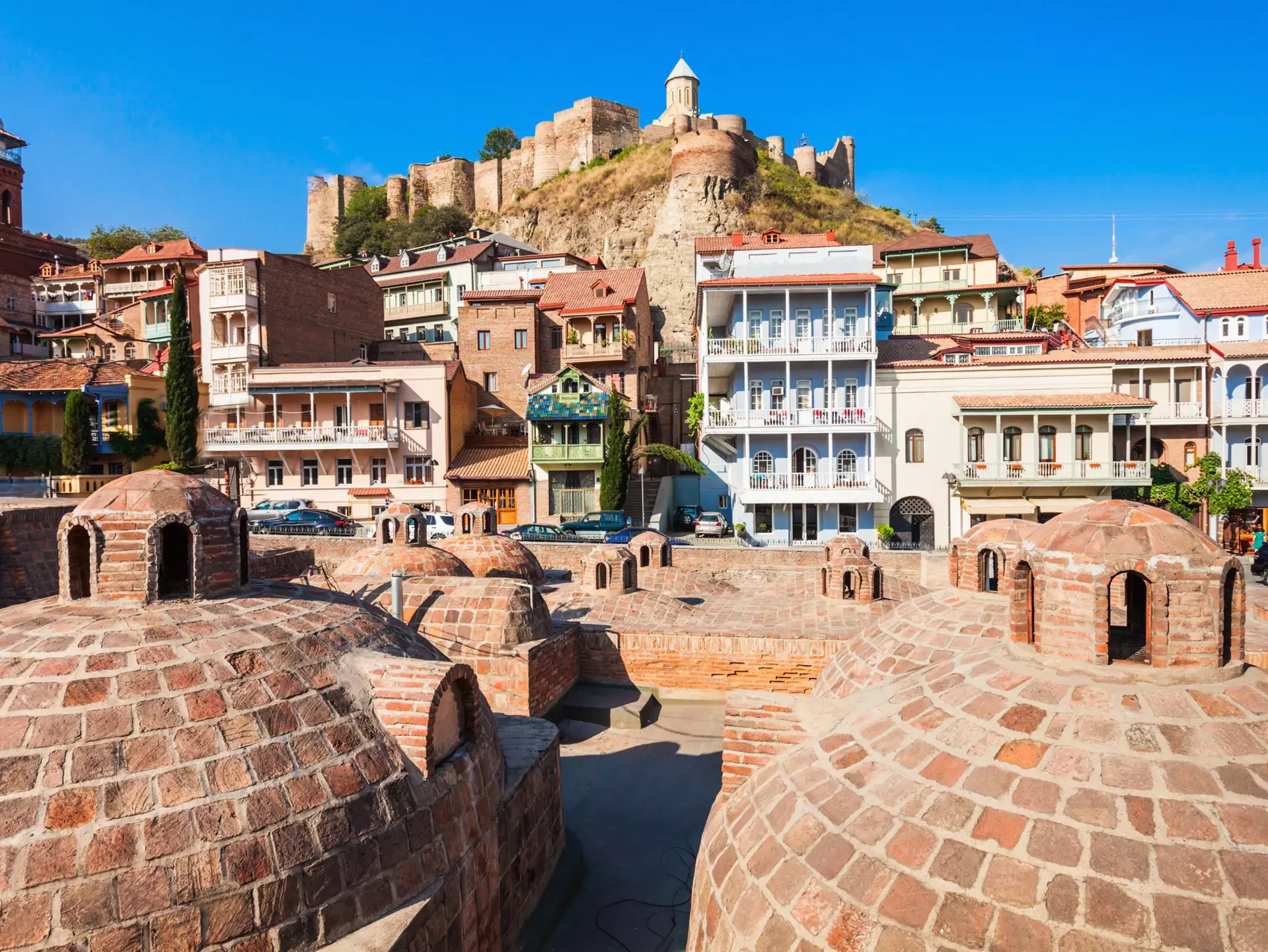 Tbilisi's Old Town is famous for its domed abanotubani (sulphur baths) and colourful houses with wooden balconies. saiko3p / Getty Images