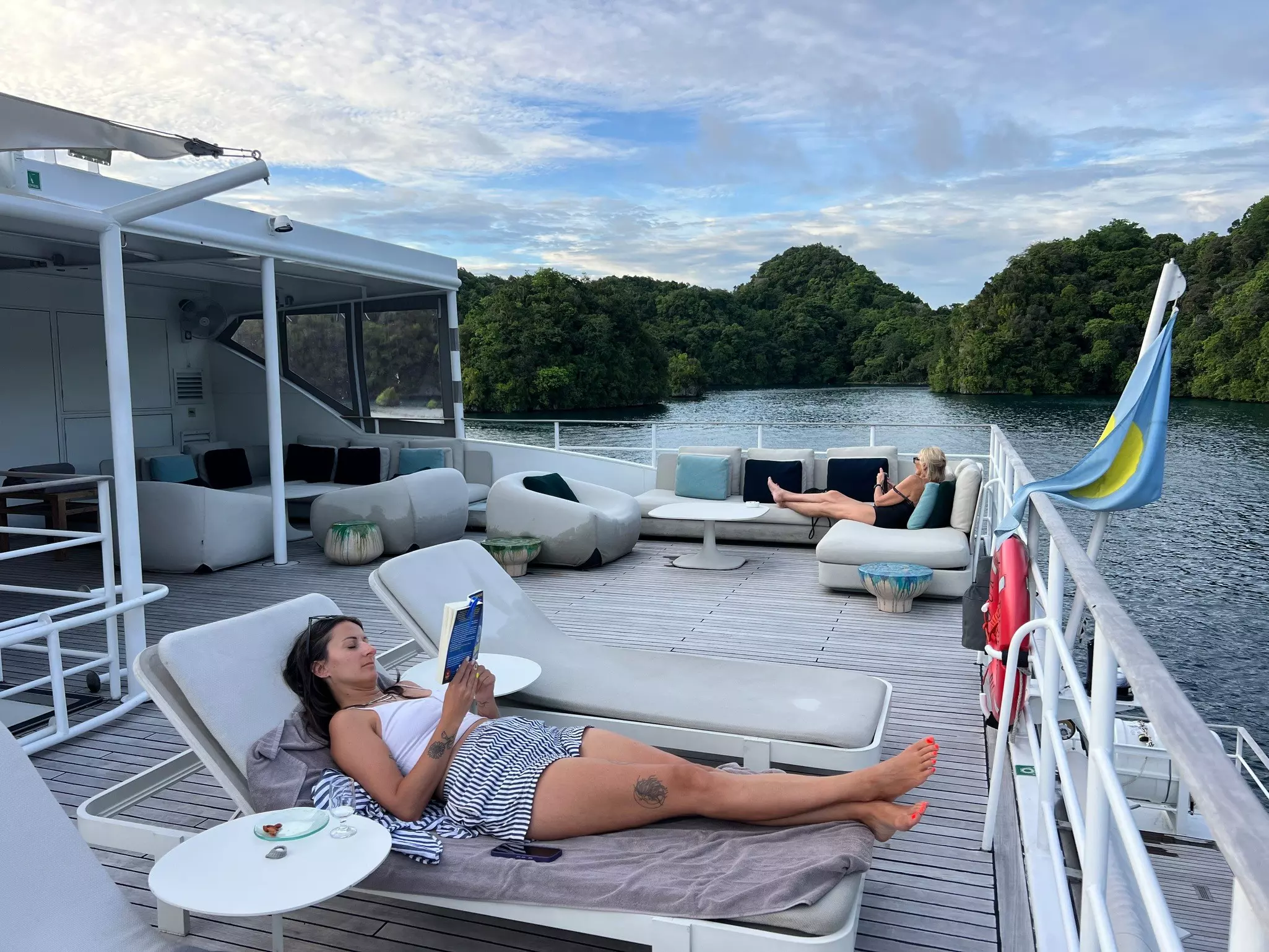Guests relax aboard the Four Seasons Explorer liveaboard boat in Palau.