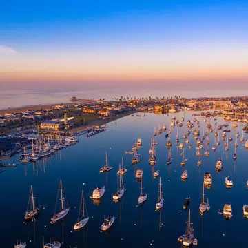 Aerial view of Newport Beach harbor in Orange County, California early in the morning with boats below.