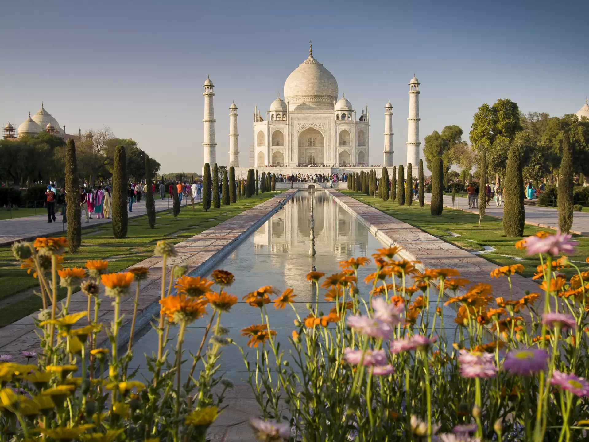 Taj Mahal with flowers in the foreground.
629824608
Architecture, Mausoleum, Agra, Photography, Full Length, UNESCO World Heritage Site, Travel Destinations, Horizontal, Color Image, People, White Color, Springtime, Taj Mahal, India, Flower, Reflection, Large Group Of People