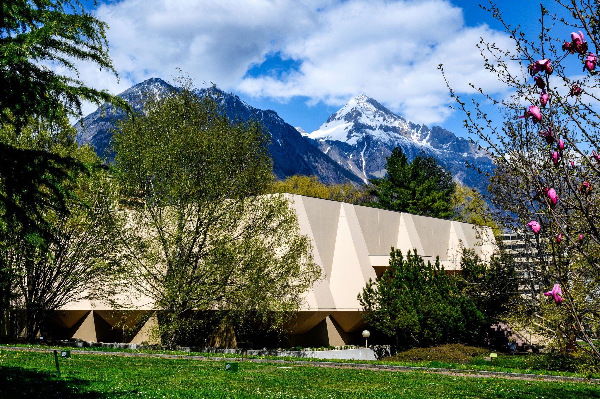 MartignySwitzerland, April 13 2021, outside view of the Pierre Gianadda Foundation on a backdrop of mountains and blue sky; Shutterstock ID 1959862153;