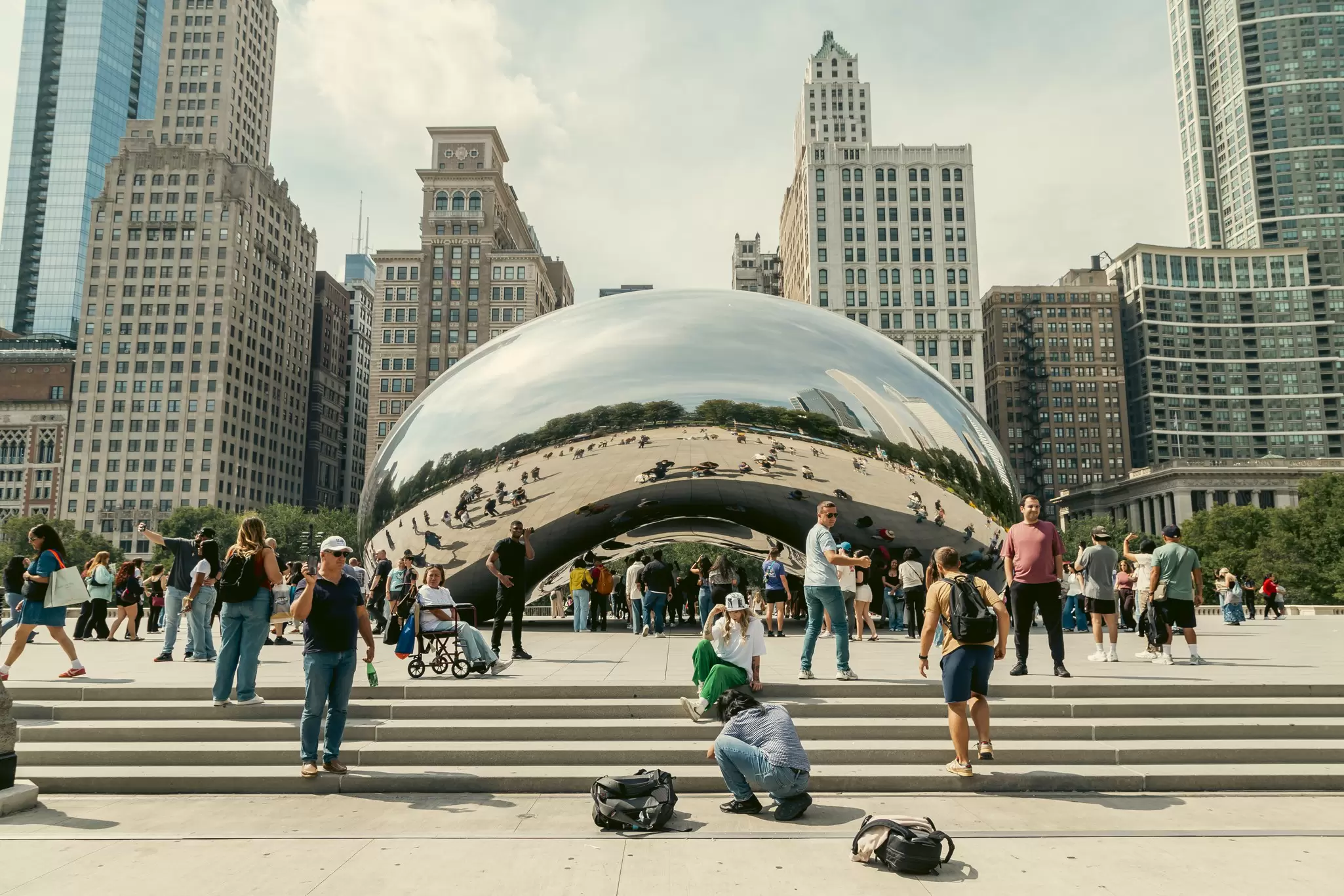 View of skyscrapers and a large bean-shaped sculpture in central Chicago