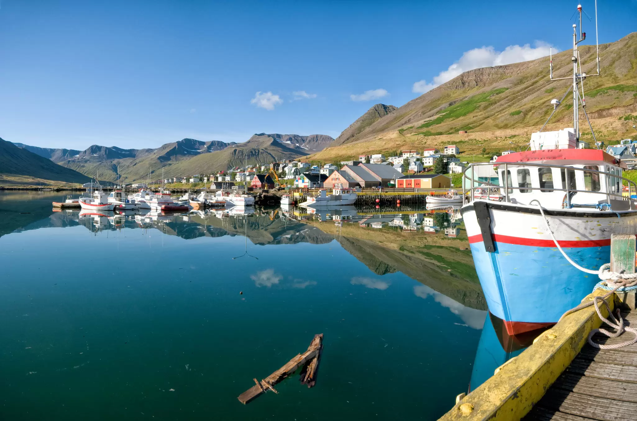 Boats docked along a beautiful port in Siglufjörður, Iceland
