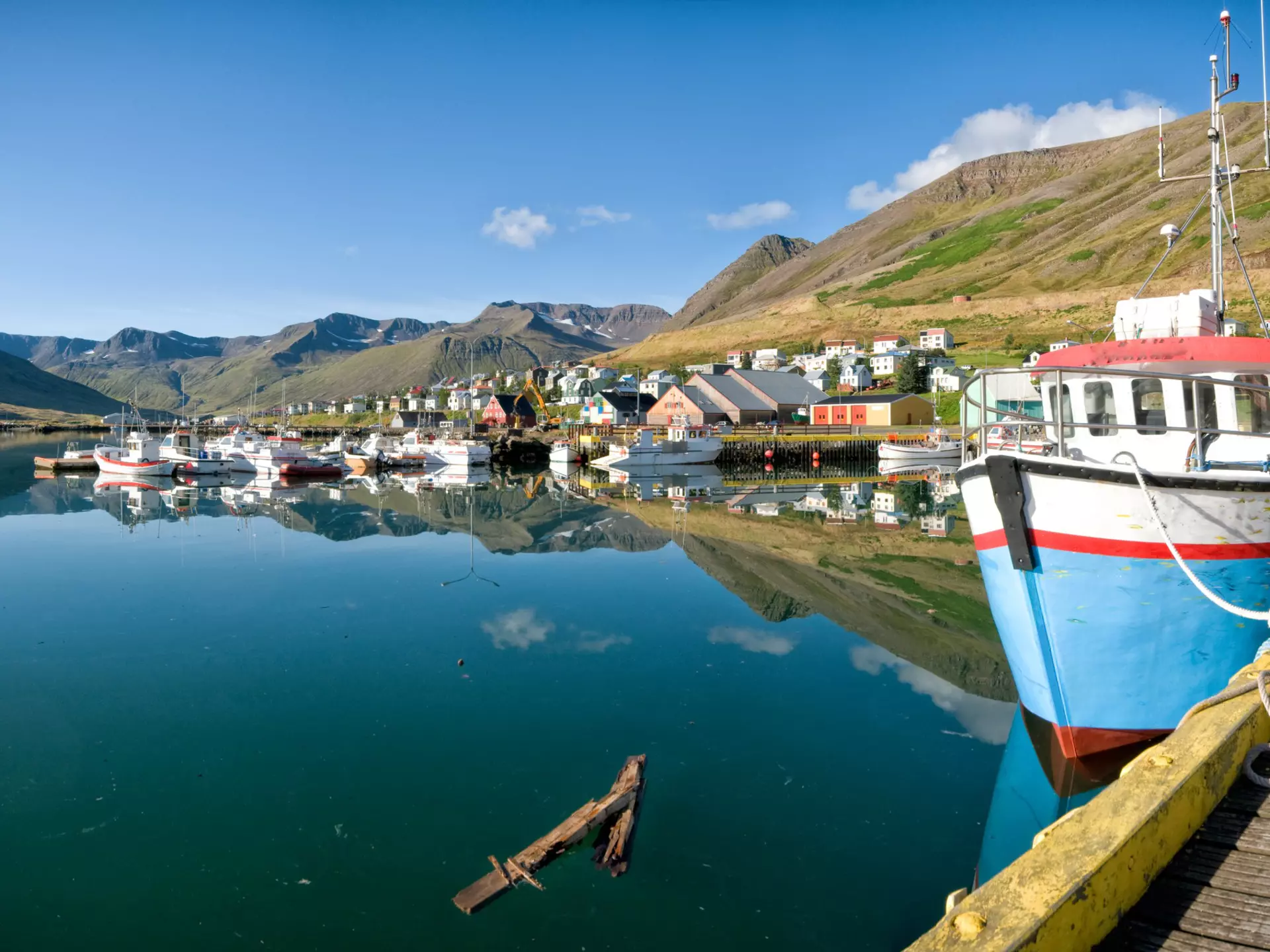 Boats docked along a beautiful port in Siglufjörður, Iceland