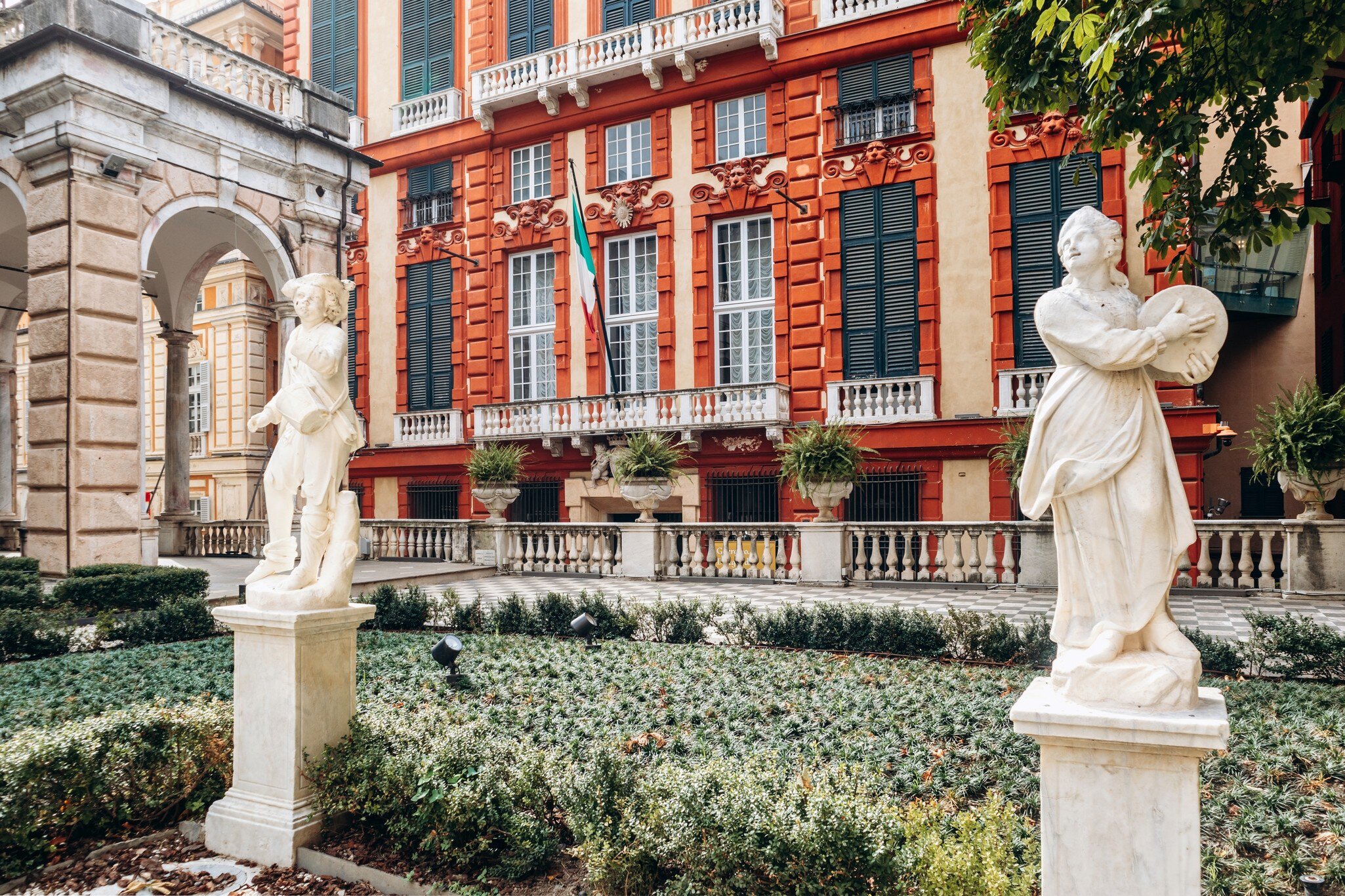 Courtyard of Palazzo Bianco in Genoa, featuring a central octagonal fountain with a faun statue.