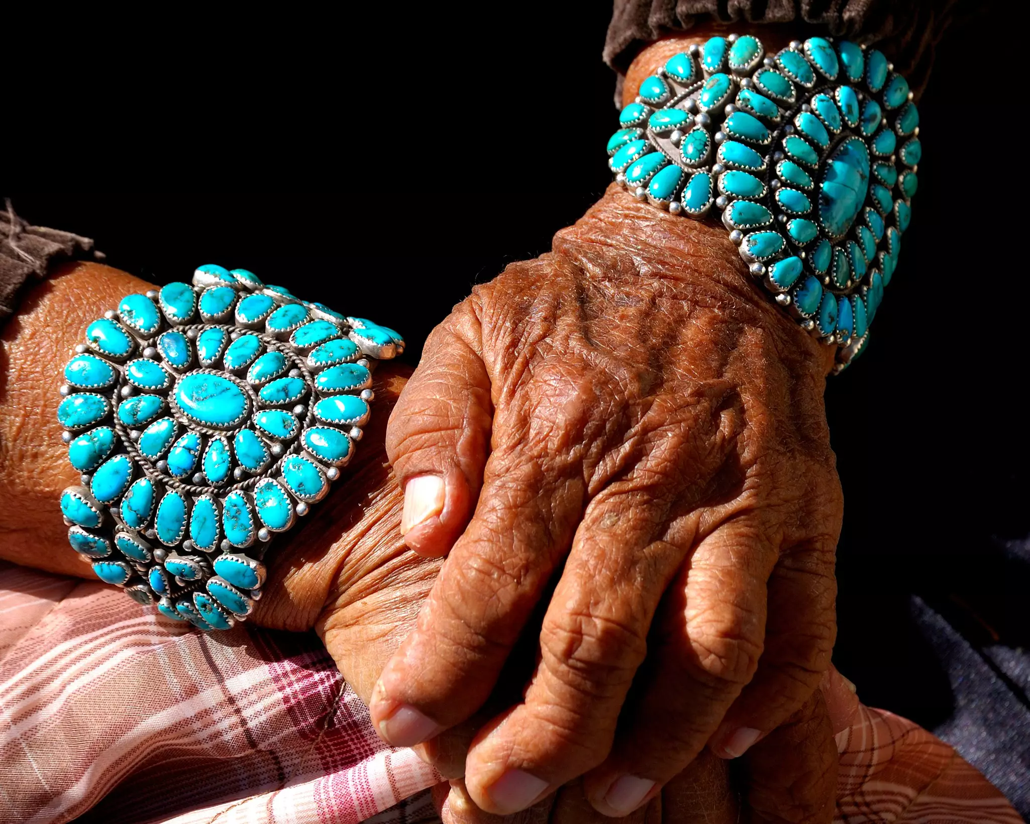 Navajo grandmother showing her turquoise bracelets. Each stone represents and significant event in her life.