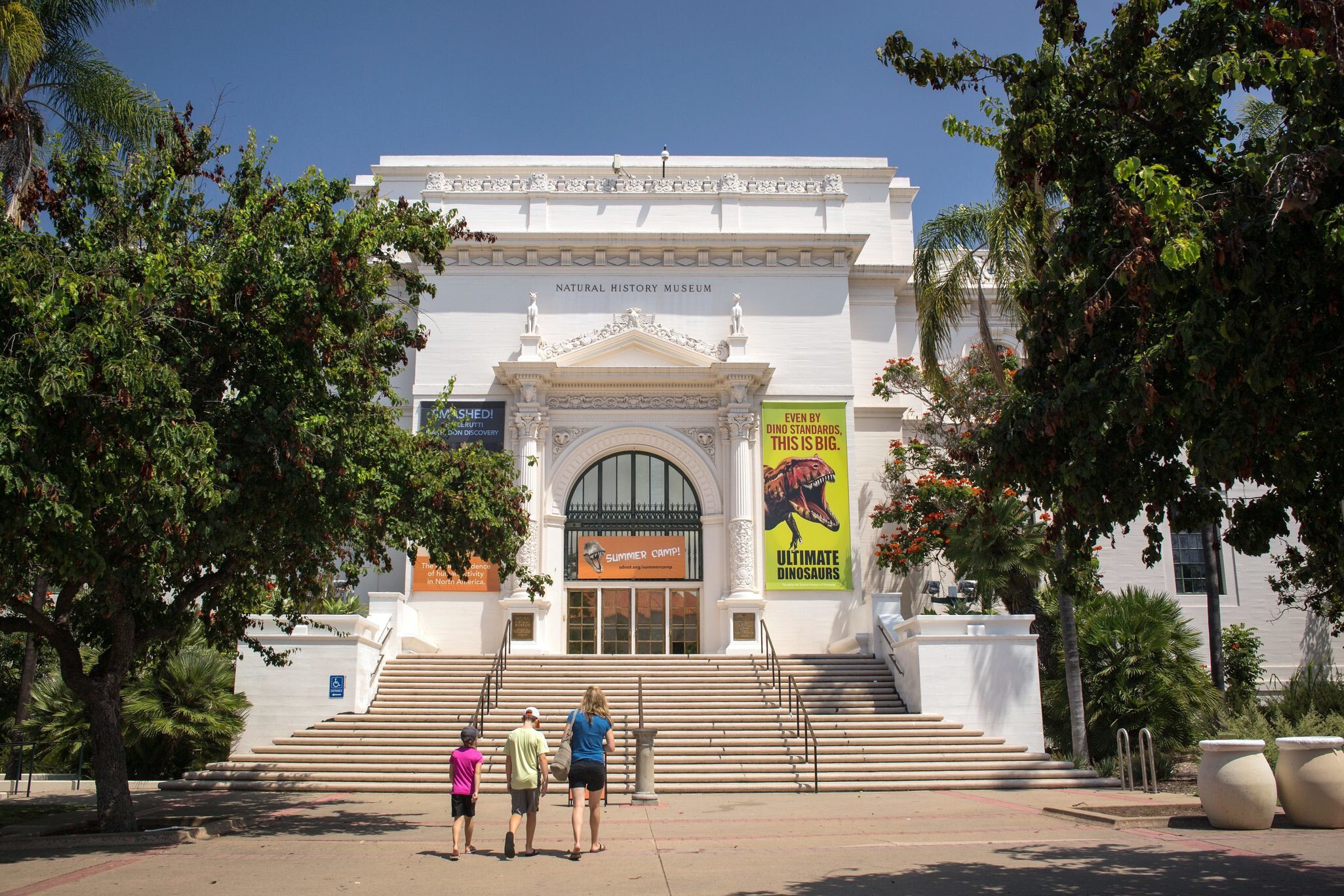 San Diego, California: Horizontal view of a mother and her two children going to the Natural History Museum entrance, Balboa Park