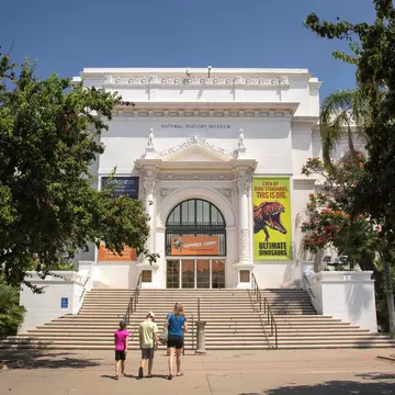 San Diego, California: Horizontal view of a mother and her two children going to the Natural History Museum entrance, Balboa Park