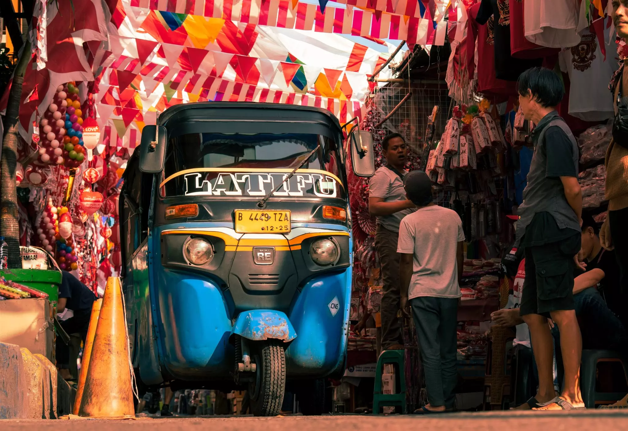 A bus in Jakarta passing through a busy market