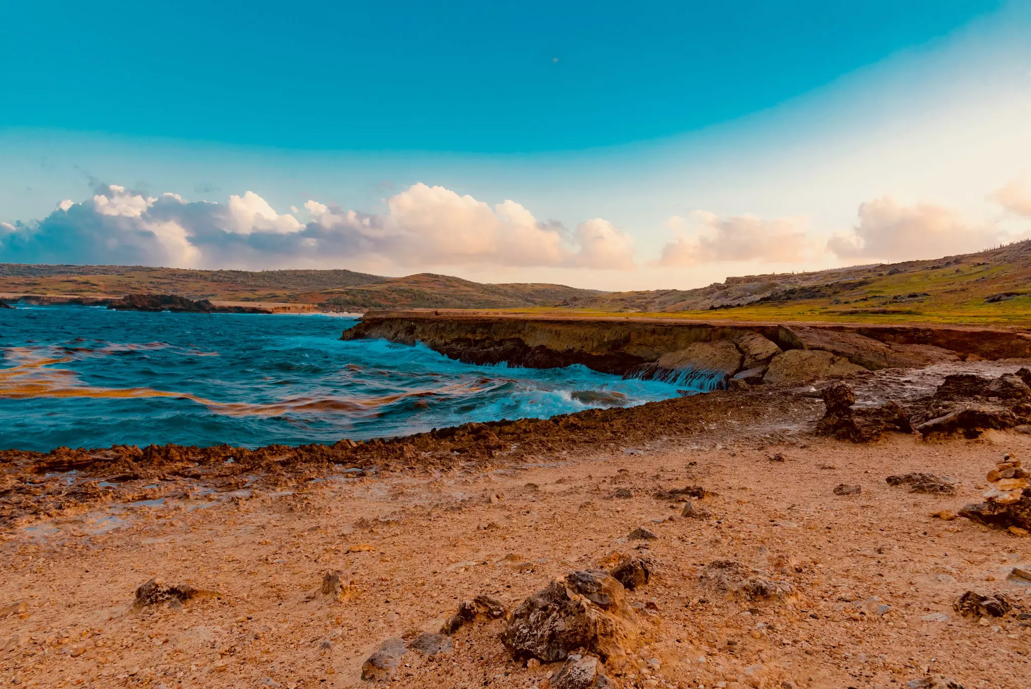 A natural blue pool with waves and clouds