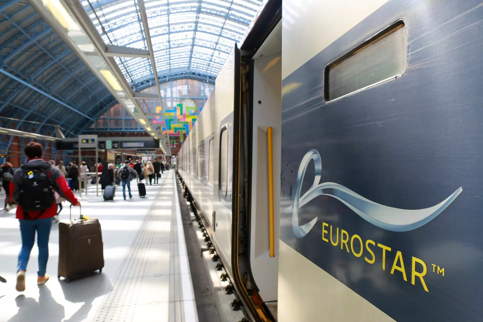People taking bags along platform after arriving from Paris into London's St. Pancras Station on the Eurostar train