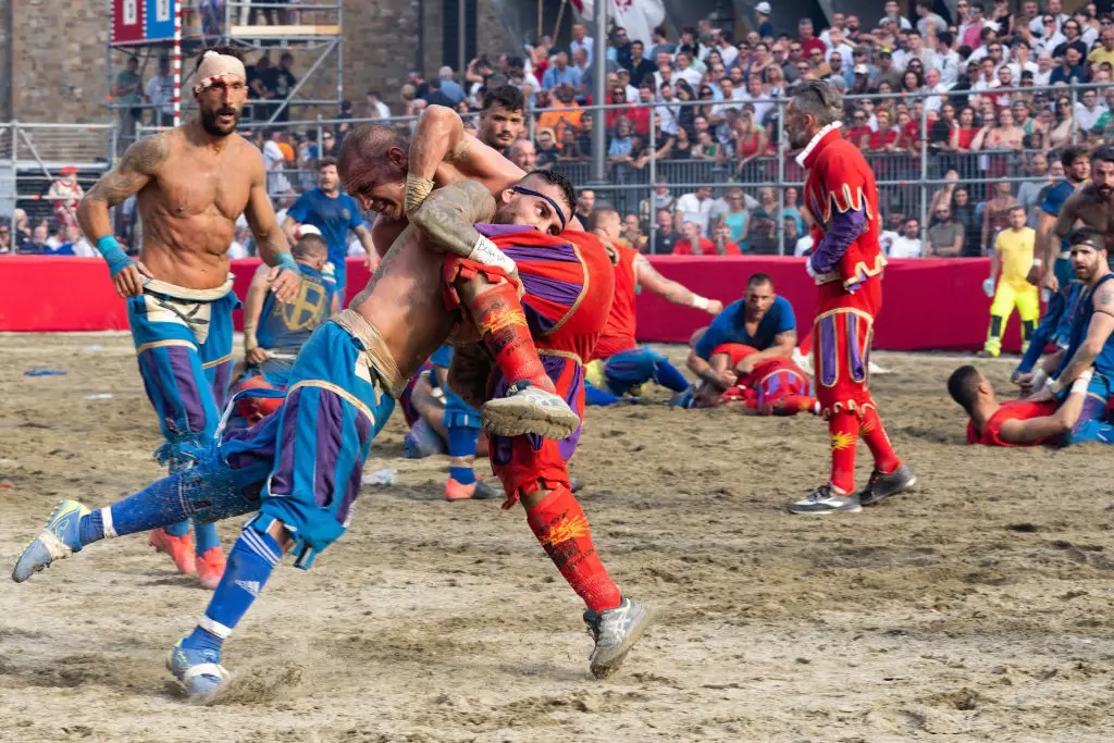 Two opposing teams wrestle during the Calcio Storico.
