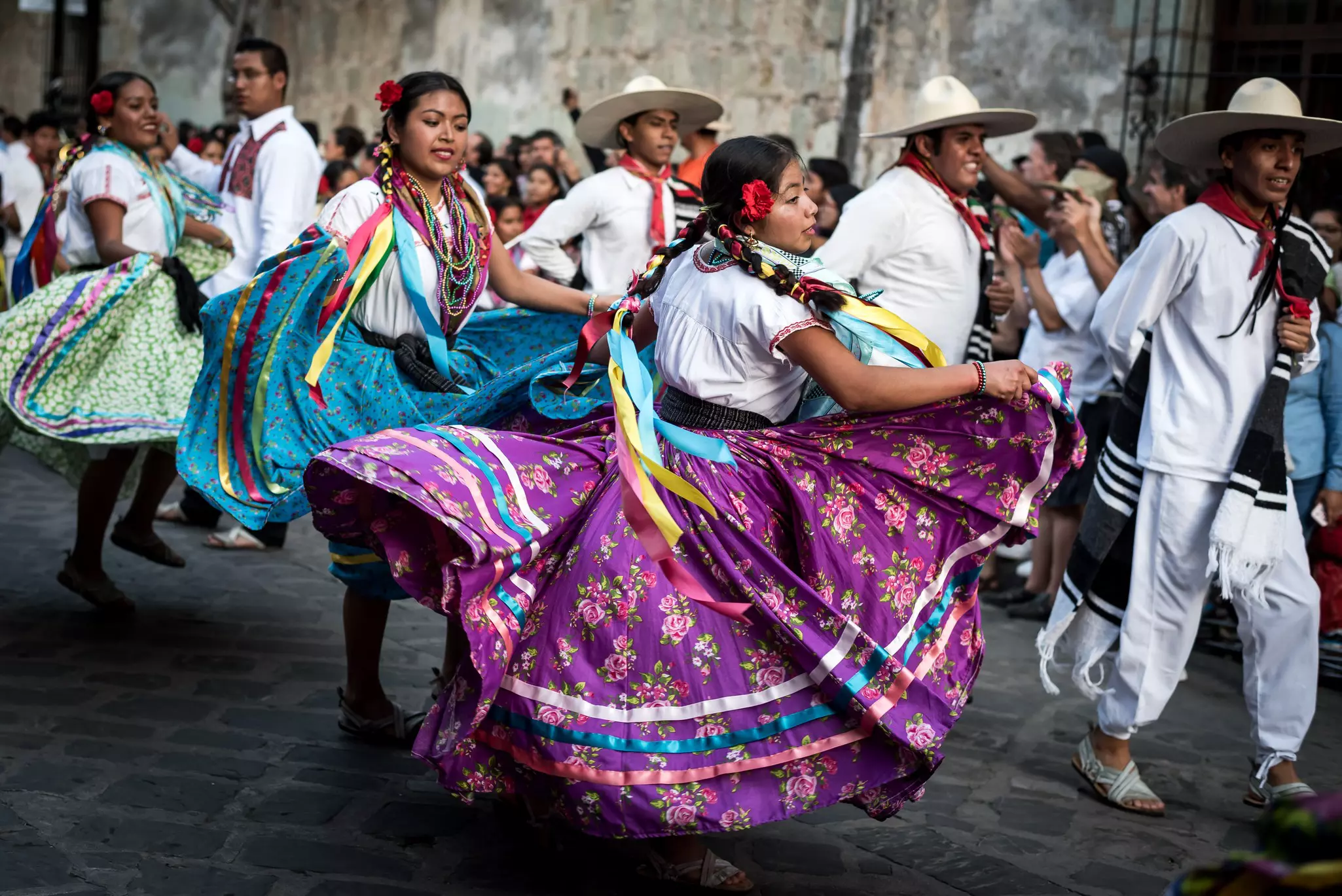 July 28, 2019: Beautiful dancers in colorful traditional dresses dancing during the Guelaguetza parade in Oaxaca, Mexico, License Type: media, Download Time: 2025-10-09T02:15:59.000Z, User: bhealy950, Editorial: true, purchase_order: 65050 - Digital Destinations and Articles, job: Lonely Planet Online Editorial, client: Best things to do in Oaxaca, other: Brian Healy