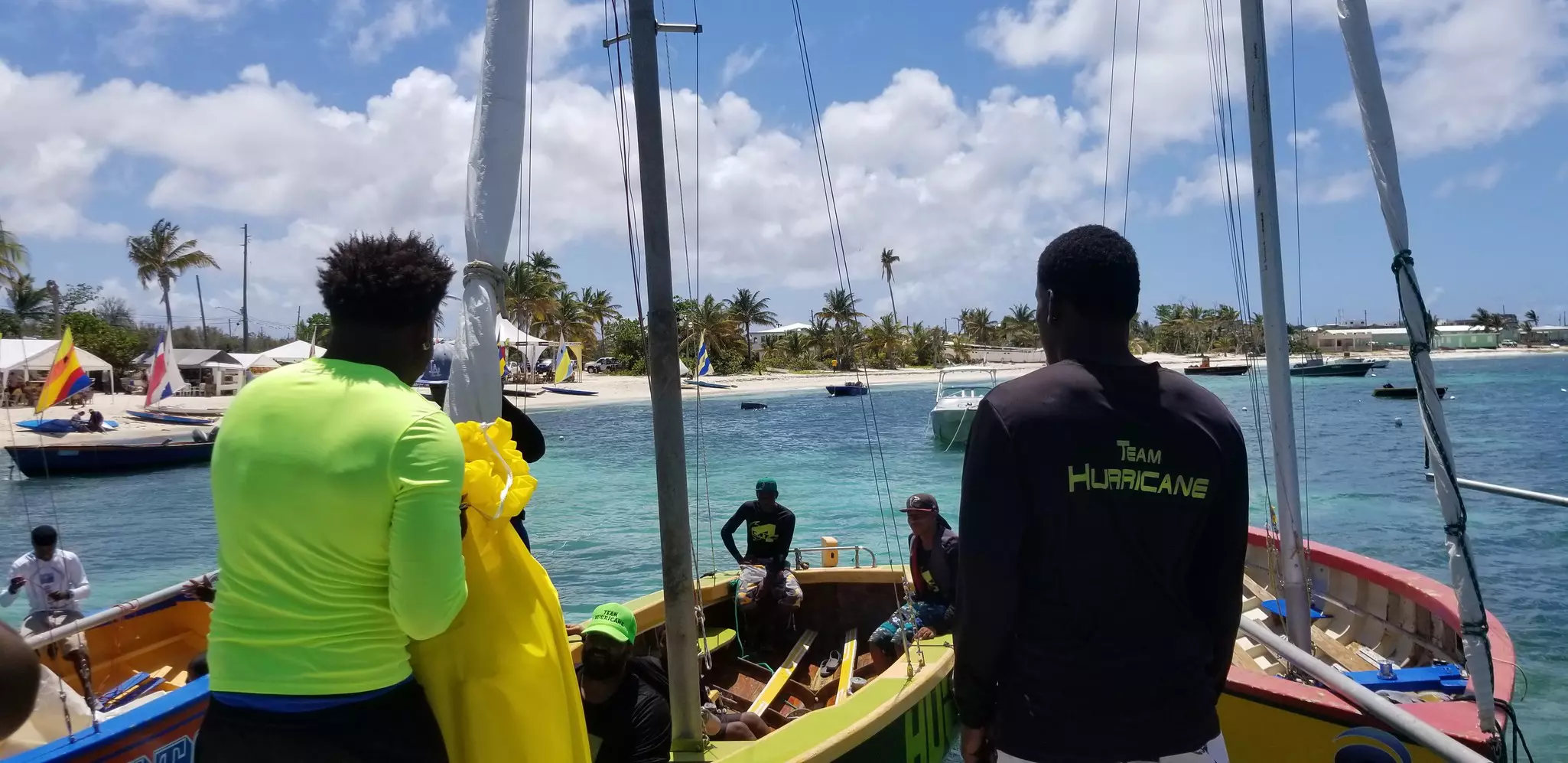 Boat crew readying a yacht before a race.