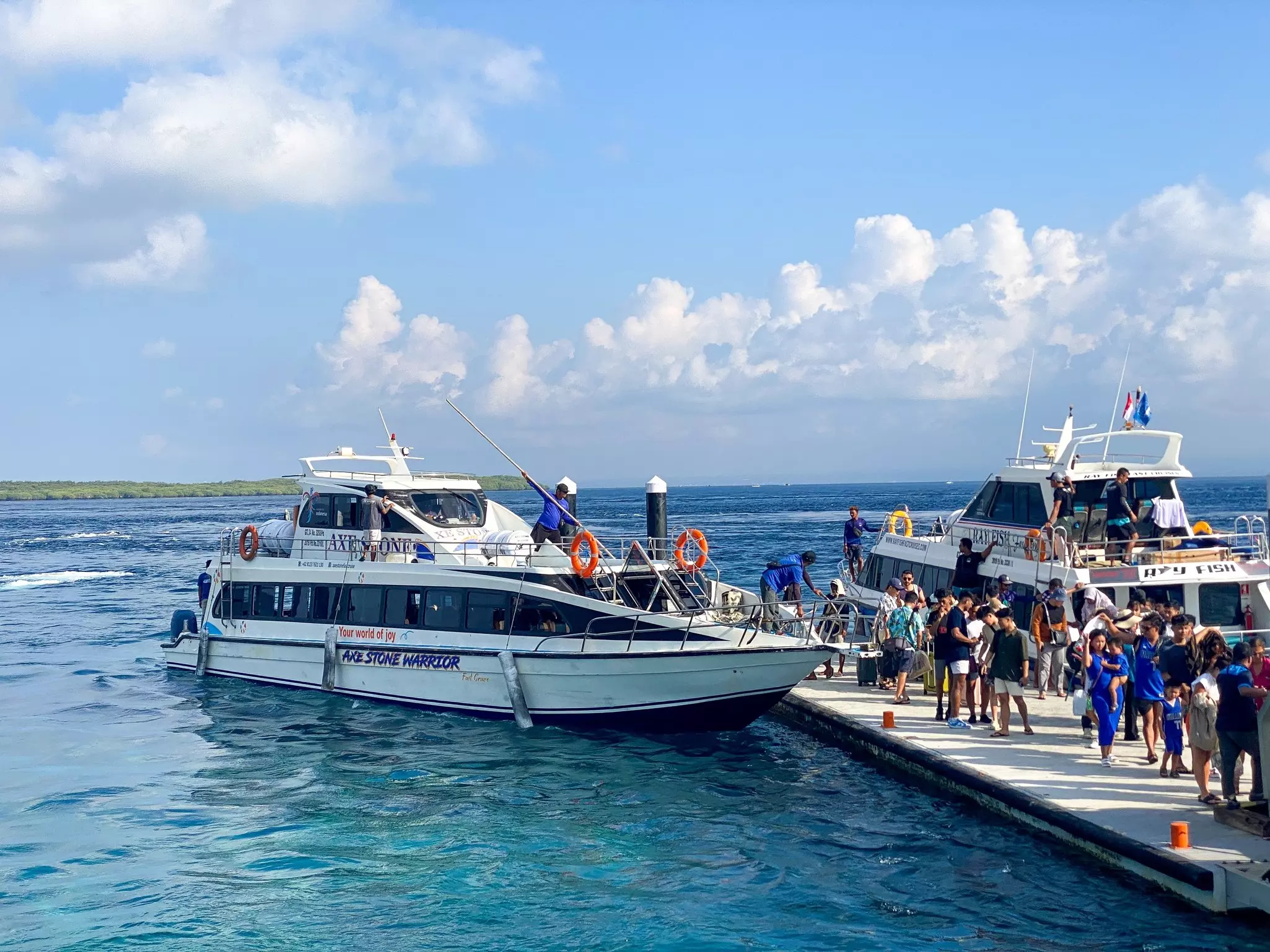 A fast-boat coming into the dock in Nusa Penida, with another nearby already docked