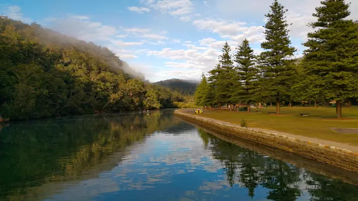 Early morning view of a river with reflections on the water.