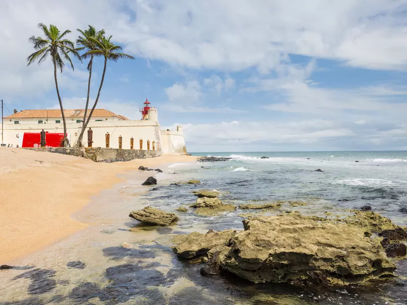 Rusty canons stand upright surounding this small coastal fort and lighthouse.