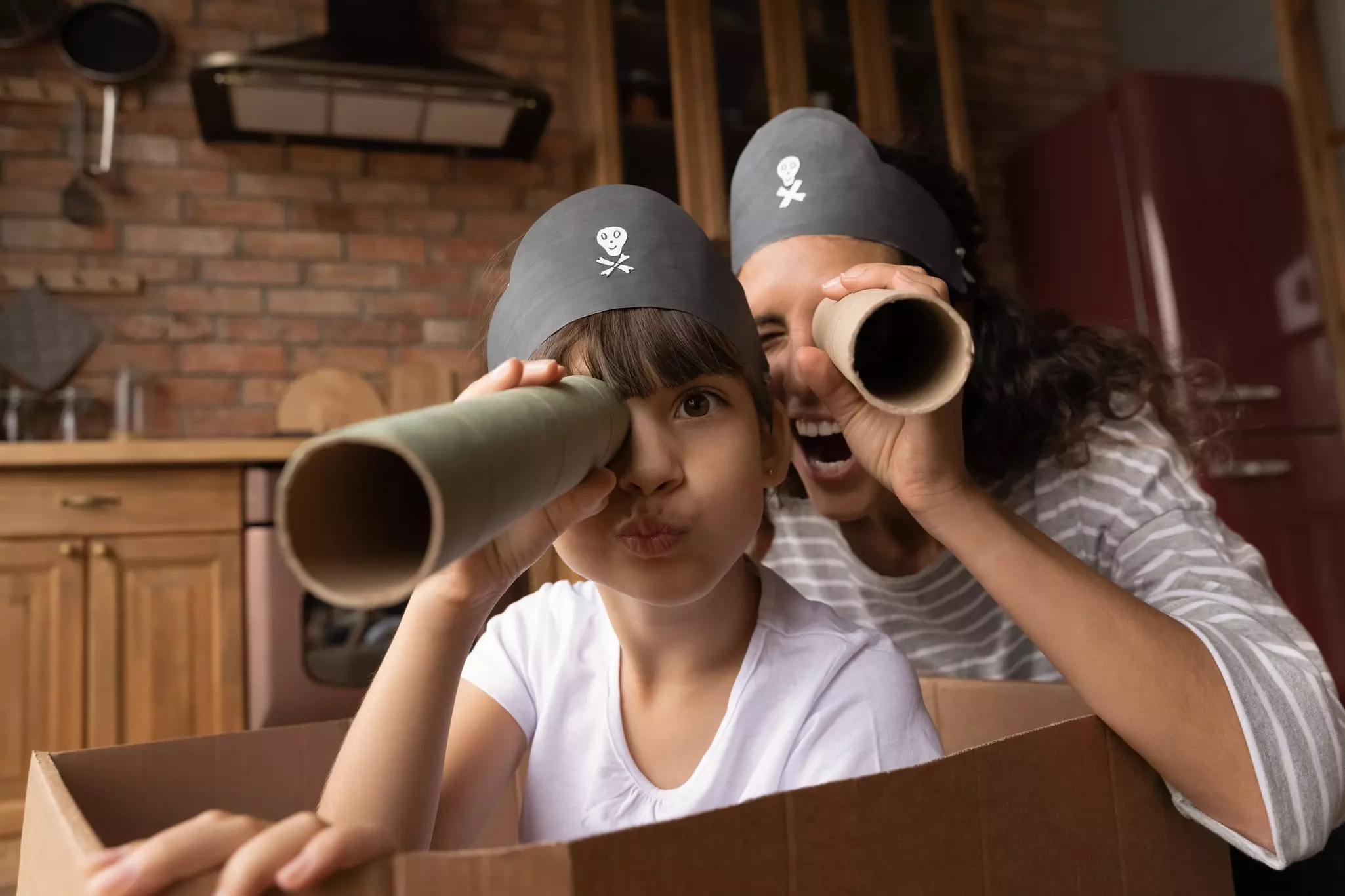 Head shot portrait happy mother and little daughter playing pirates, looking at camera, excited mum and preschool gild child wearing handmade costumes, holding paper tubes as spyglass, having fun, License Type: media, Download Time: 2024-10-29T11:21:30.000Z, User: joe_lp, Editorial: false, purchase_order: 56500 - T&R or Kids, job: Global Publishing WIP, client: Create Your Own Camping Activities, other: Joe Fullman