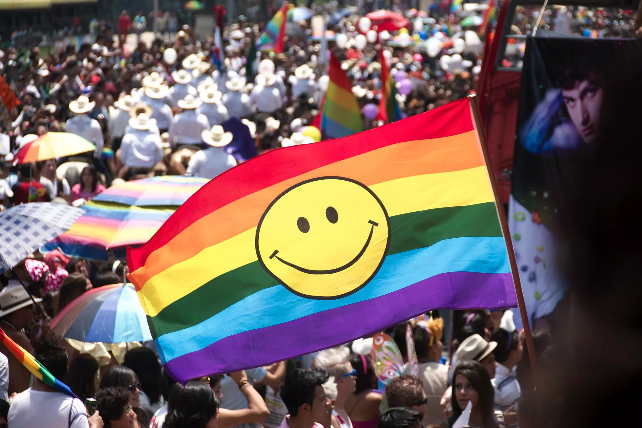 A riot of red, yellow and blue curlicues made of glass are stacked into a tall tower and illuminated, visible from several layers of balconies on all sides; Where to see Chihuly in America