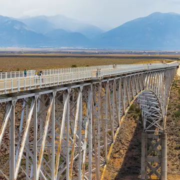 TAOS, NM, USA-6 JULY 2018:  The Rio Grande Gorge Bridge, on US 64 south of Taos is the second highest bridge in the US Highway system, and the fifth highest bridge in the country.    License Type: media  Download Time: 2022-03-07T02:56:46.000Z  User: claramonitto  Is Editorial: Yes  purchase_order:   
