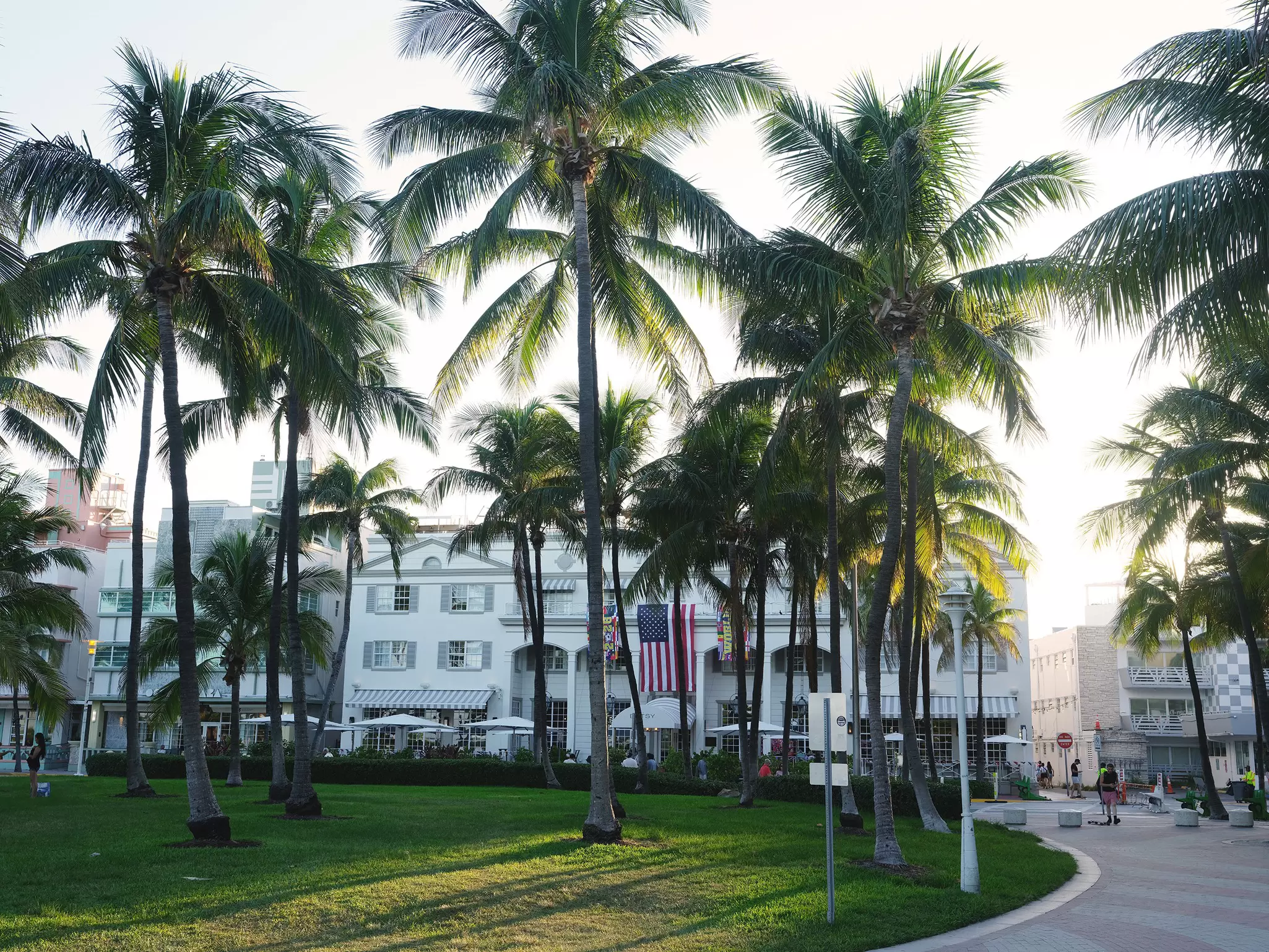 Palm trees line the gardens outside a grand hotel; the Betsy Hotel in South Beach, Miami.