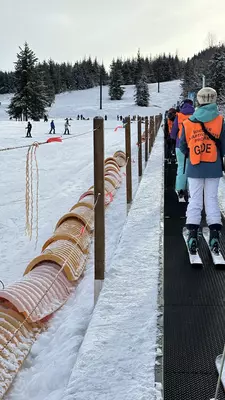 Adaptive guides (in orange vests) teaching ski lessons on Whistler Blackcomb.