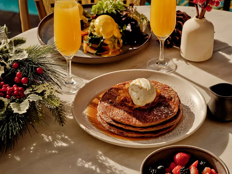 A plate of pancakes and a mimosa. 