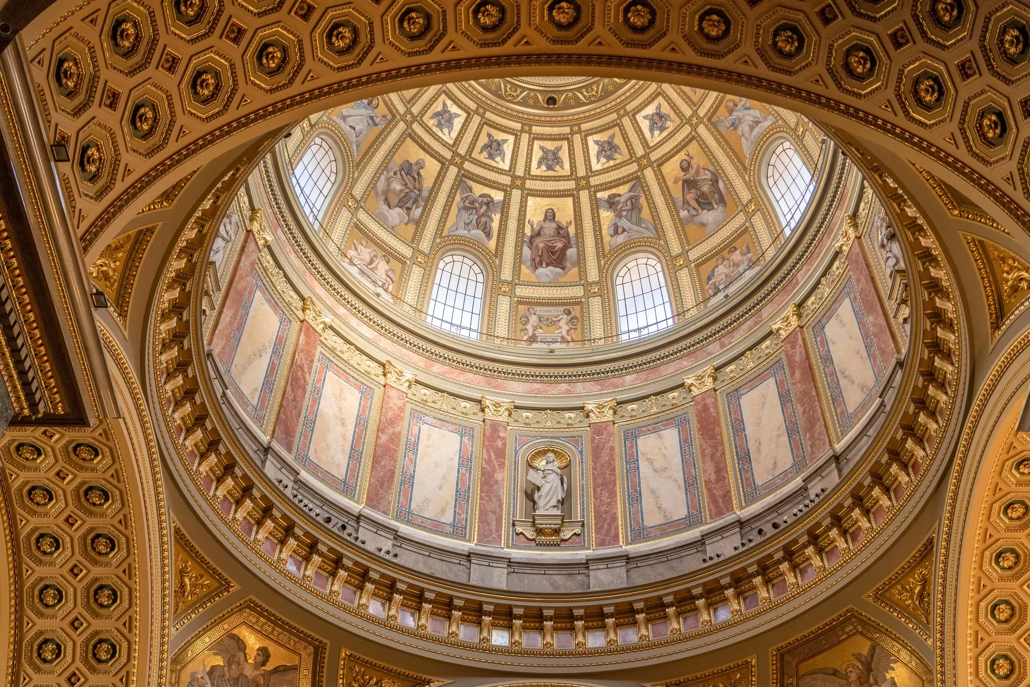 Upward view of the golden dome cupola inside the Basilica of St Stephen in Budapest, Hungary.