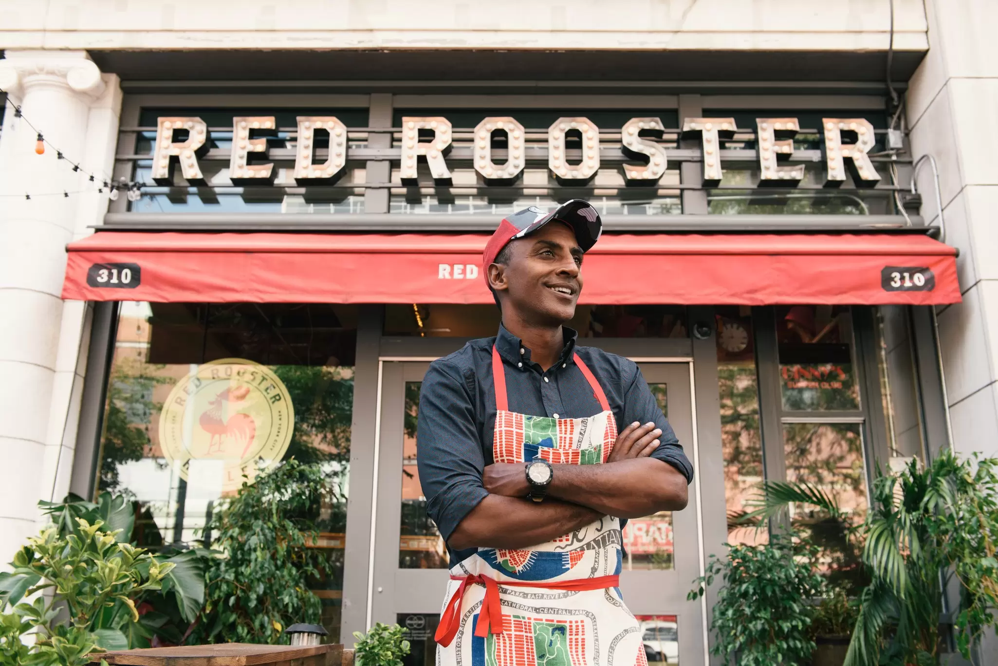 Chef and Harlem denizen Marcus Samuelsson in front of his already-legendary Harlem restaurant Red Rooster © courtesy Red Rooster