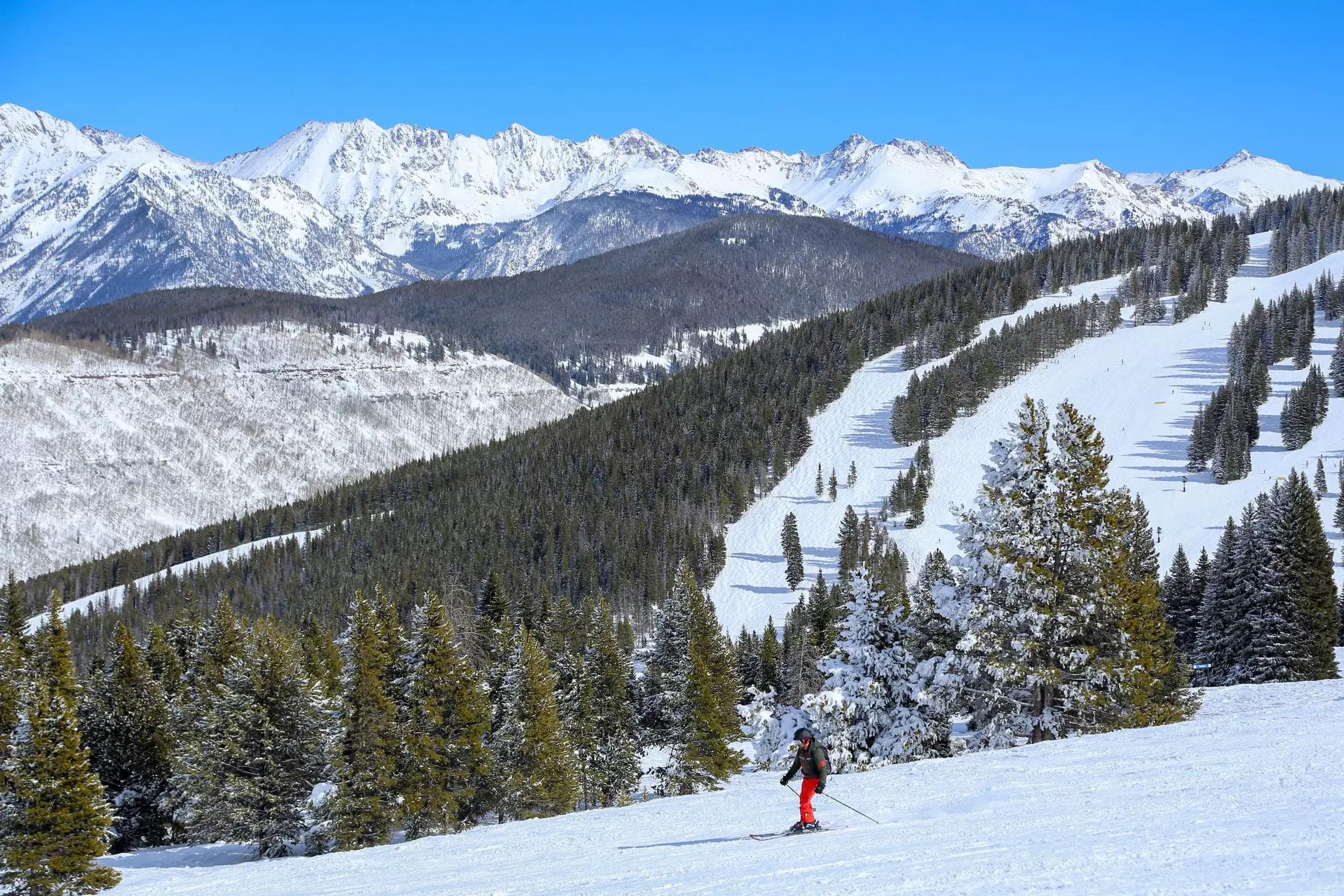 Male skier at Vail Ski resort in the Colorado Rocky Mountains on a blue sky day