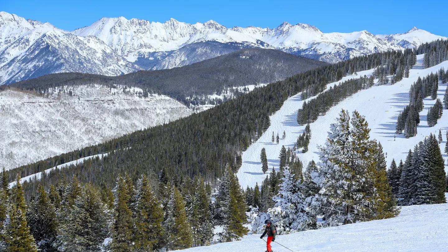 Male skier at Vail Ski resort in the Colorado Rocky Mountains on a blue sky day