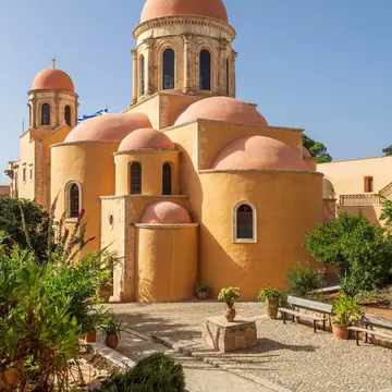 Exterior of the beautiful Agia Triada Monastery dates back to the 17th century, illuminated by the sun on Crete.