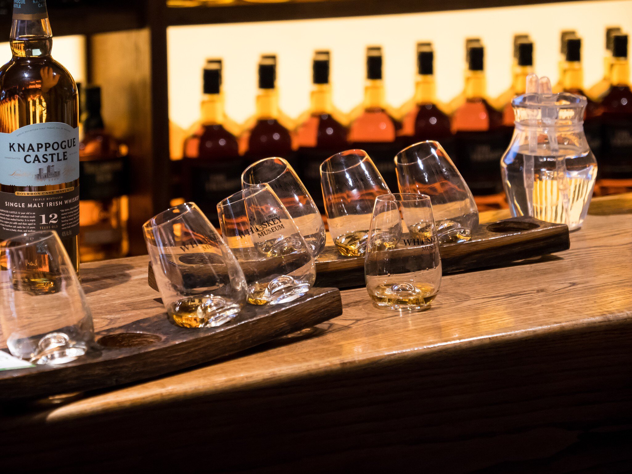 Empty whiskey glasses on a bar counter at the Irish Whiskey Museum. The Dublin Whiskey Museum explains history of Irish Whiskey and invites to taste a few of them.
