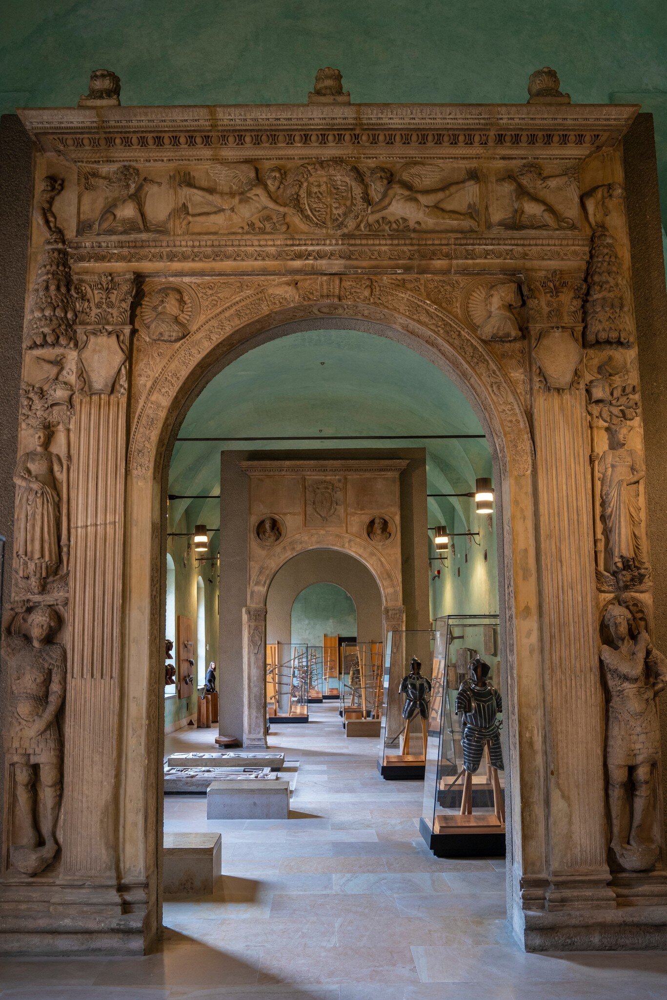 The hall with a funerary sarcophagus and other funerary excavations, statues and sculptures at the exhibit in the museum of the Sforzesco Castle.