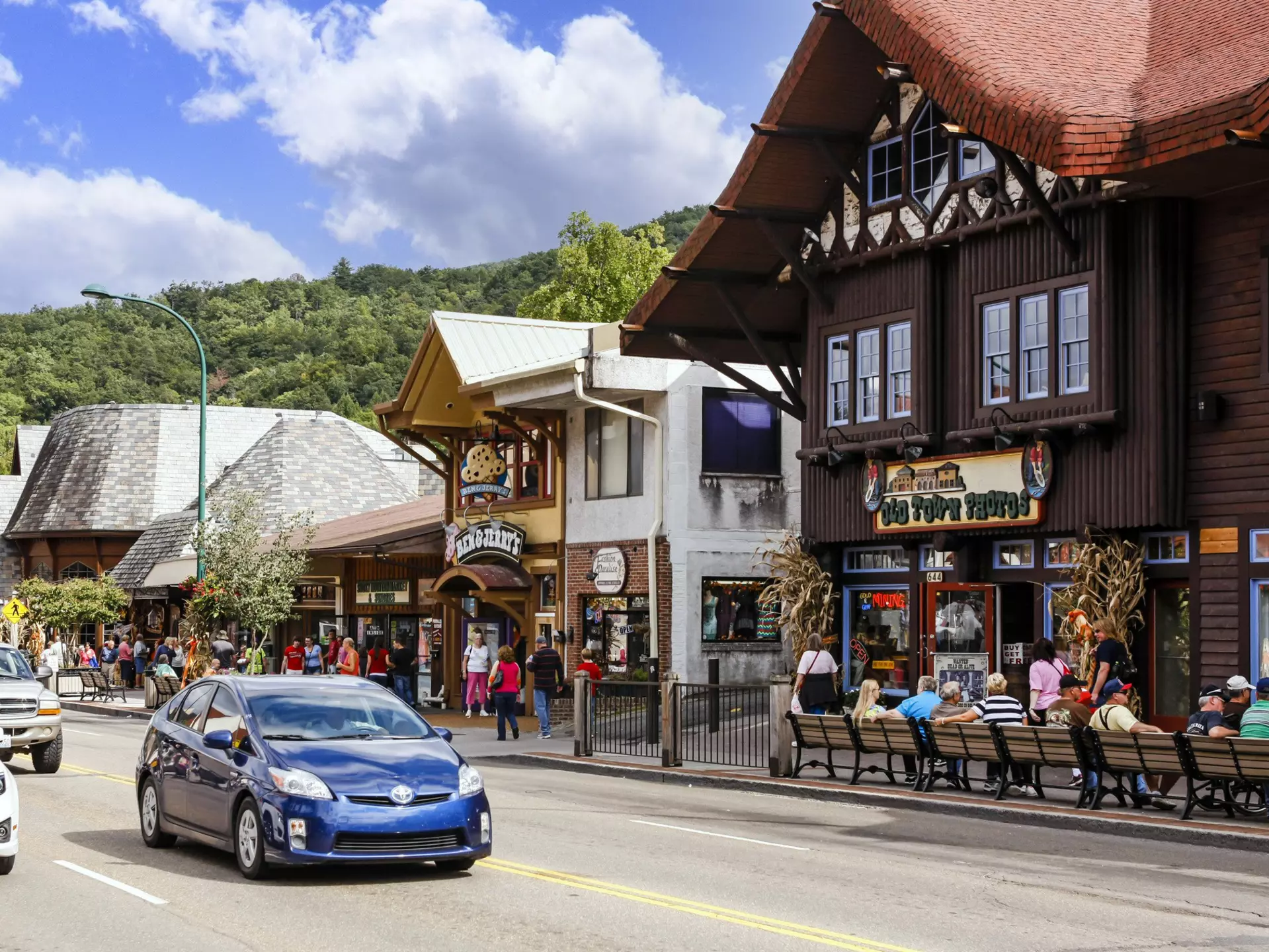 People walking around Main Street in downtown Gatlinburg Tennessee, USA. The street has an old-world feel to it, with heritage buildings, where people eat and drink outside.