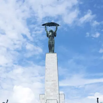 View of the Liberty Statue and Citadel located at the top of Gellért Hill in Budapest, Hungary.