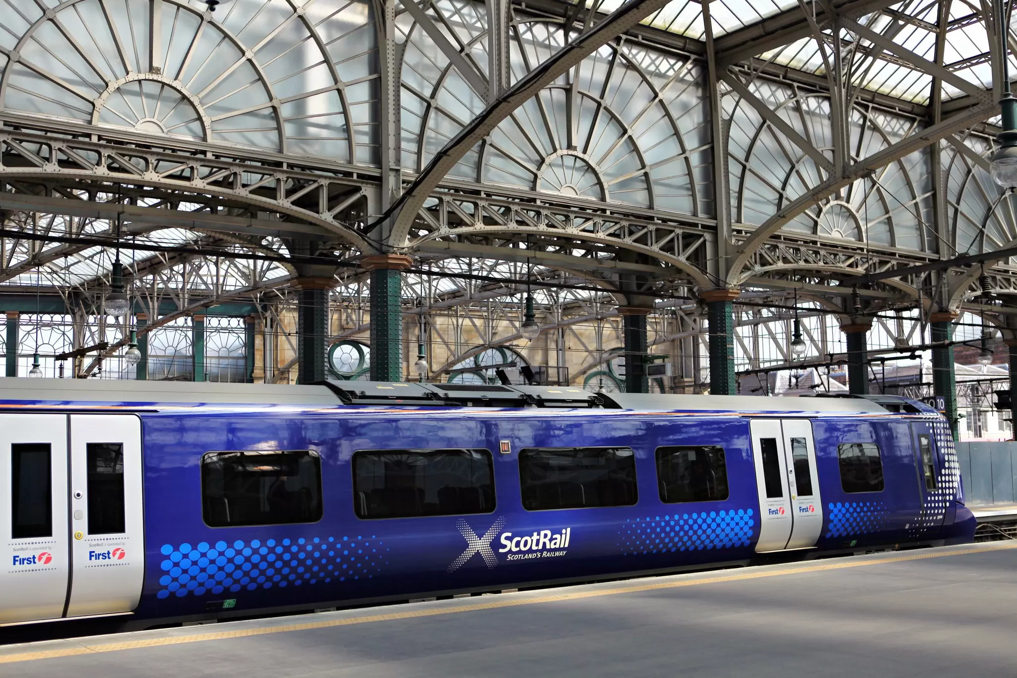 A train traveling through the Scottish landscape