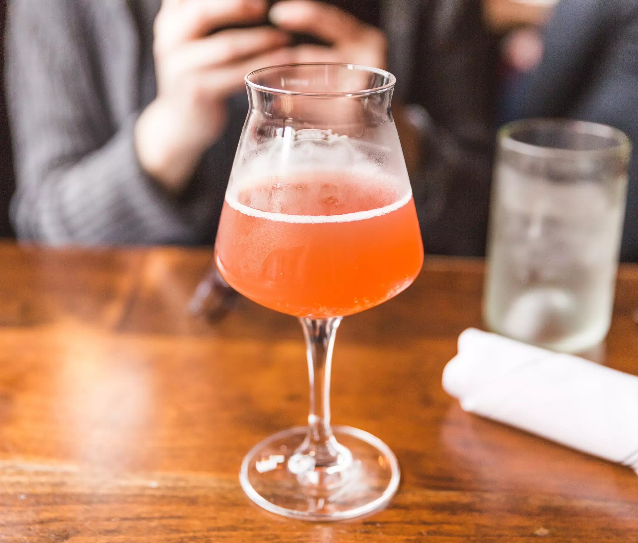An orange-colored drink served in a glass