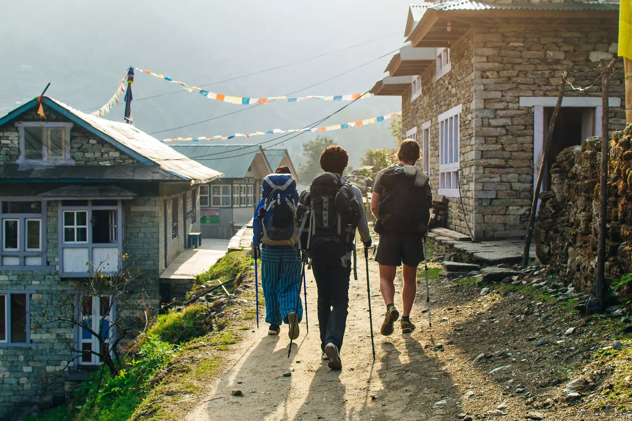 Hiker trekking in green mountains on trail between Jiri and Lukla - lower part of Everest trek in Himalayas, Near Karikhola village.