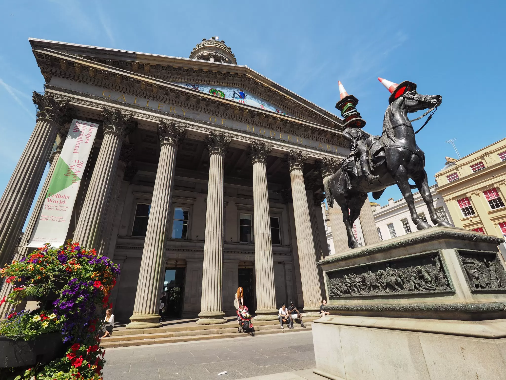 The famous statue of the Duke of Wellington is covered with a stack of traffic cones at the front of the Gallery of Modern Art.