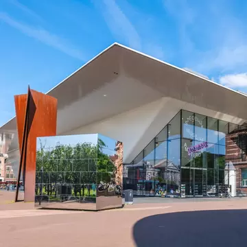 Exterior view of the Stedelijk Museum on a sunny day in Amsterdam.