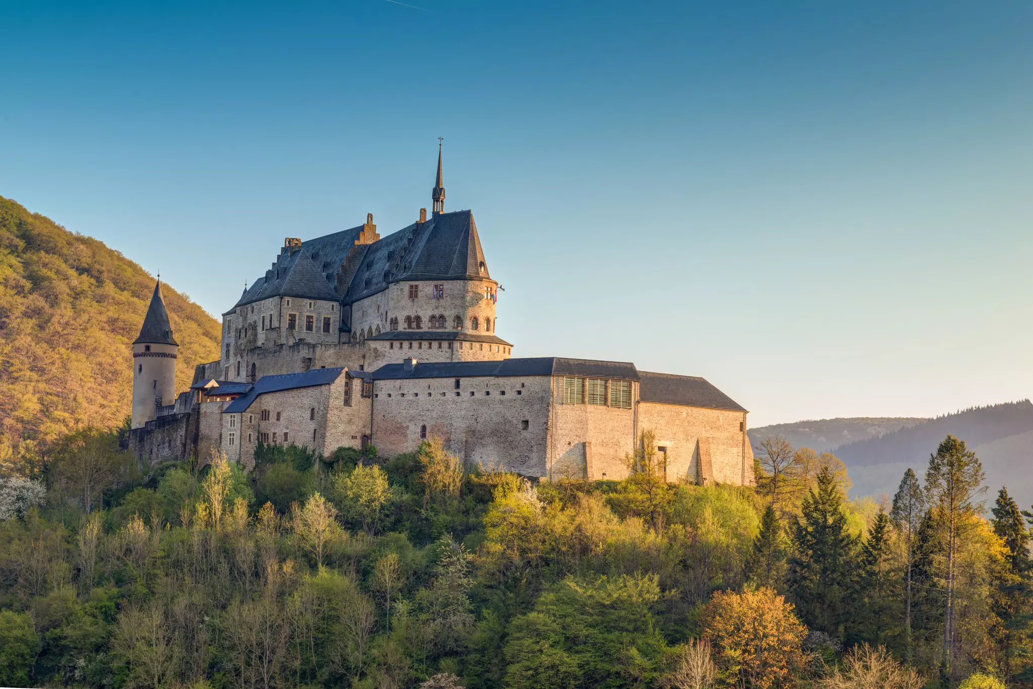 The medieval castle rising above the forest in Vianden, Luxembourg.