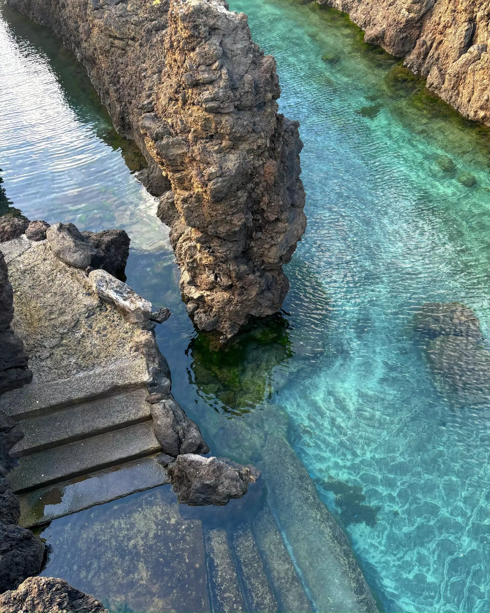 Natural lava-rock pools in Porto Moniz, Madeira, Portugal. Stone steps into the water